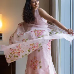 A playful shot showing the beautiful movement of the lightweight organza saree. It’s a perfect "titli moment".