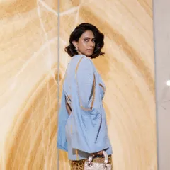 This hairstyle features sculpted, retro-inspired waves for a short bob. It adds a touch of vintage glamour and sophistication, perfectly complementing the high-fashion look for a Dior event.