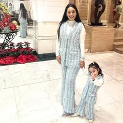 Twinning in style, even in winter. This custom powder blue tweed co-ord set, for both mother and daughter, is a chic and cozy option for cooler weather, blending classic fabric with a contemporary silhouette.