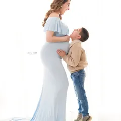 Pure, unscripted joy during a studio maternity shoot. The laughter between a mother and her son is a memory that will be treasured for years to come.