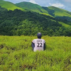 A moment of peace, soaking in the vast green landscapes of the Bandaje trek. I believe the journey itself is the reward, and I make sure you have time to appreciate it.