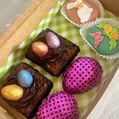 A peek inside one of my custom Easter hampers. This box is filled with a curated selection of my seasonal goodies, including egg nest brownies, hand-decorated marzipan eggs, and foil-wrapped chocolate eggs.
