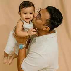 A sweet kiss from dad. These are the tender, candid moments that beautifully illustrate the father-child bond.