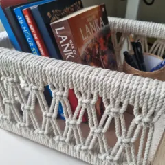 My multipurpose macrame baskets are where function meets beauty. This one, shown here holding books, is built on a sturdy wooden frame, making it perfect for organizing your essentials or creating a beautiful, personalized gift hamper.