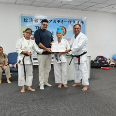 This student's hard work has paid off as she earns her blue belt. The presence of parents and senior instructors makes the belt examination ceremony a memorable occasion.