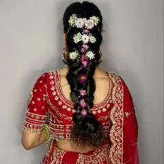 A beautiful and intricate floral braid using baby's breath and other small flowers. This hairstyle is perfect for a unique and modern bridal look.