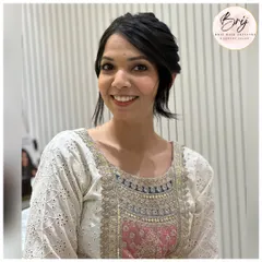 A happy client with her elegant updo. The style is clean and sophisticated, with soft tendrils to frame her face beautifully.