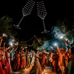 Elevate your sangeet or reception with a celebratory drone formation. Here, sparkling champagne glasses toast the happy couple as guests dance and celebrate below, creating a dynamic and festive party atmosphere.