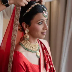 Nothing is more classic than a bride in a traditional red saree. To balance the vibrant color, I created a look with kohl-rimmed eyes for timeless definition, paired with fresh, glowing skin and a floral bun, ensuring the overall feel was elegant and rooted in tradition.