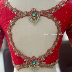 A centered view of the heart-shaped back, highlighting the symmetrical embroidery and the sparkling pendant-like details.