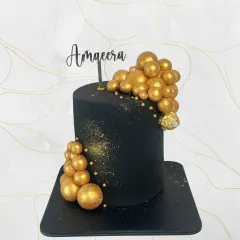 Black and gold is a timeless combination for a sophisticated celebration. This cake for Aqeera features a cascade of golden spheres and a touch of gold dust for extra sparkle.