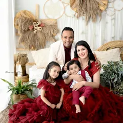 A returning family, now as a party of four! It's an honor to capture families as they grow. This portrait, with everyone in coordinated red outfits, is full of warmth and happiness.
