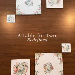 A table for two, redefined. This flat lay showcases our coordinated floral collection, including placemats and coasters in various sizes, designed to bring a touch of botanical elegance to your table.