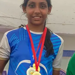 A close-up of a champion with her well-earned medals. This level of success is what our competitive archery program is designed to achieve.