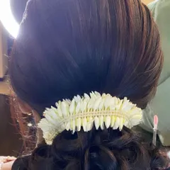 A detailed shot of the jasmine gajra on a classic bun, showing the fresh, fragrant flowers.