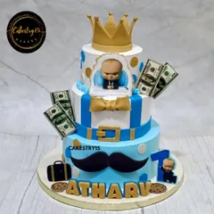 A stylish three-tier Boss Baby cake for a first birthday. This 4kg chocolate cake features the iconic suit, a golden crown, and edible money accents for a fun, "little boss" theme.