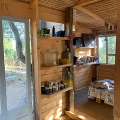 The interior of our retreat accommodation in Sardinia, filled with natural light. The environment is designed to be simple, clean, and supportive of your sadhana.