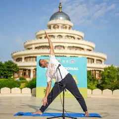 A yoga instructor demonstrates a posture during the International Day of Yoga celebrations. We focus on the authentic practice of yoga for holistic well-being.