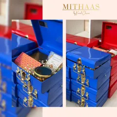 These vibrant metal trunks in royal blue and festive red are perfect for creating budget-friendly yet luxurious hampers. Their sturdy build and classic design make them a gift that lasts long after the treats are gone.