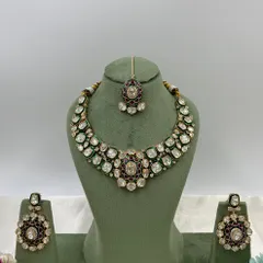 A pair of stunning oversized earrings with green and red Meenakari work, set with Moissanite stones. These are perfect as standalone statement pieces.