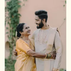 A heartwarming portrait of a groom and his mother sharing a loving gaze. This candid moment captures the special bond between them on the wedding day.