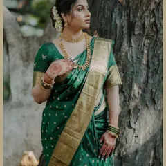 An elegant three-quarter portrait of the bride in her beautiful green Maharashtrian saree. The natural light and classic pose highlight her grace and poise.