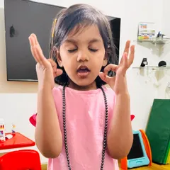 My daughter showing us her meditation pose. It's important to acknowledge and praise good behavior, not just correct the bad. This photo is a reminder to celebrate our children's efforts and positive actions, which builds their confidence and emotional intelligence.