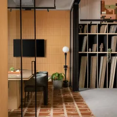 The meeting space within the Trove showroom combines a strong visual identity with everyday function. Our custom graphic tiles create a dynamic floor, while the open shelving keeps a library of material samples organized and accessible for design discussions.