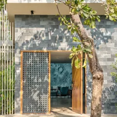Our Moon House was featured in Elle Decor India for its unique "Focus on Surfaces." The article highlights the artistic, hand-plastered lunar surface wall in the living room, which gives the home its name and character.