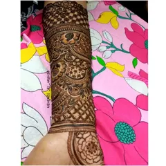 A single arm covered in a dense, intricate pattern. This view highlights the beautiful check-patterned cuff design on the upper forearm.