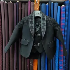 I also create matching outfits for fathers and sons. This is a miniature version of a groom's wedding suit, complete with intricate hand embroidery, ensuring the little one looks just as dapper.