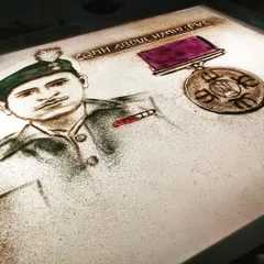 This is a frame from a short film on the Battle of Asal Uttar, depicting the hero CQMH Abdul Hamid, PVC. We use colored sand to highlight significant details like the medal, bringing more life to these historical tributes.