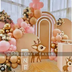 A sweet and gentle woodland theme for a first birthday. This setup features an adorable deer cutout, "ONE" blocks, and a soft, neutral color palette of pink and tan balloons for a heartwarming celebration.
