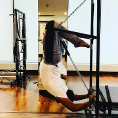 Using the Cadillac to achieve a deep stretch and build spinal mobility. A flexible body is a strong body.