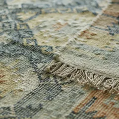 The corner of one of our dhurries, highlighting the fringe and the texture of the weave. This is where you can see the magic of handwoven craftsmanship and the care that goes into each piece.