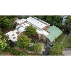 My designs work with the land, not against it. This aerial view of the Foothill Learning Centre shows how the building's flowing forms are nestled among existing trees, creating a campus that feels like a natural extension of the landscape.