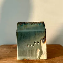 Another piece from our mini house series, with a subtle green glaze and small, carved windows that add character.