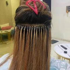 A close-up view of micro ring extensions during application. You can see the neat rows and how the individual strands create a very natural, integrated look.