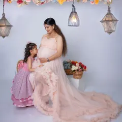 The bond between a mother and her child begins long before they meet. Here, a soon-to-be big sister shares a quiet, precious moment with her mother, whispering secrets to the baby on the way.