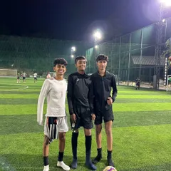 Teammates on the pitch after a tough night session. The hard work continues under the floodlights as we prepare for the next challenge.