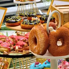 A colorful and playful display of donuts with various icings. This is part of our creative dessert offering, where we blend flavors from across continents to serve memories.
