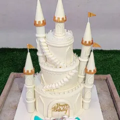 For a true fairytale celebration, I create grand, multi-tiered castle cakes like this one. The intricate details, from the towering turrets to the delicate swans, are all handcrafted to make your princess's dream come true.