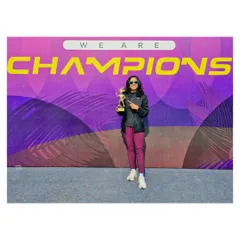 Standing in front of the "We Are Champions" banner says it all. This win was a testament to a strategic race plan and consistent training.