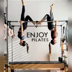 Enjoying the view from upside down. The Cadillac allows for amazing spinal decompression and strength building, as our instructors demonstrate here.