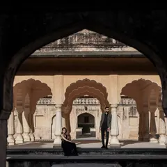Framing your love story within the grand arches of a historic monument. This wide shot captures the scale and magnificence of the location, making the couple's moment feel both epic and intimate.