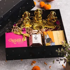 My "Diya" hamper is a perfect example of elegant festive gifting. Housed in a modern, sleek black box, it contains traditional brass idols of Lakshmi and Ganesh, alongside artisanal honey and gourmet Indian sweets for a truly regal touch.