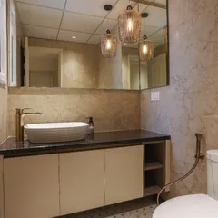 A modern bathroom vanity designed with a premium matt laminate finish for a subtle, sophisticated look. The handleless cabinet doors and open side shelving provide a clean, uncluttered appearance while offering practical storage.