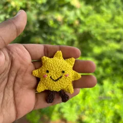 A solo shot of the happy sun keychain. It's a little pocketful of sunshine to brighten your day.