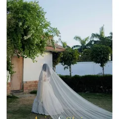 An elegant and dreamy portrait of a bride-to-be on her engagement day. The long, flowing veil creates a sense of romance and anticipation for the journey ahead.