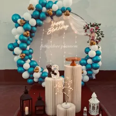 From elegant to playful, I design birthday backdrops that become the centerpiece of your celebration. This full-circle balloon arch in blue, white, and gold adds a touch of class to any party.